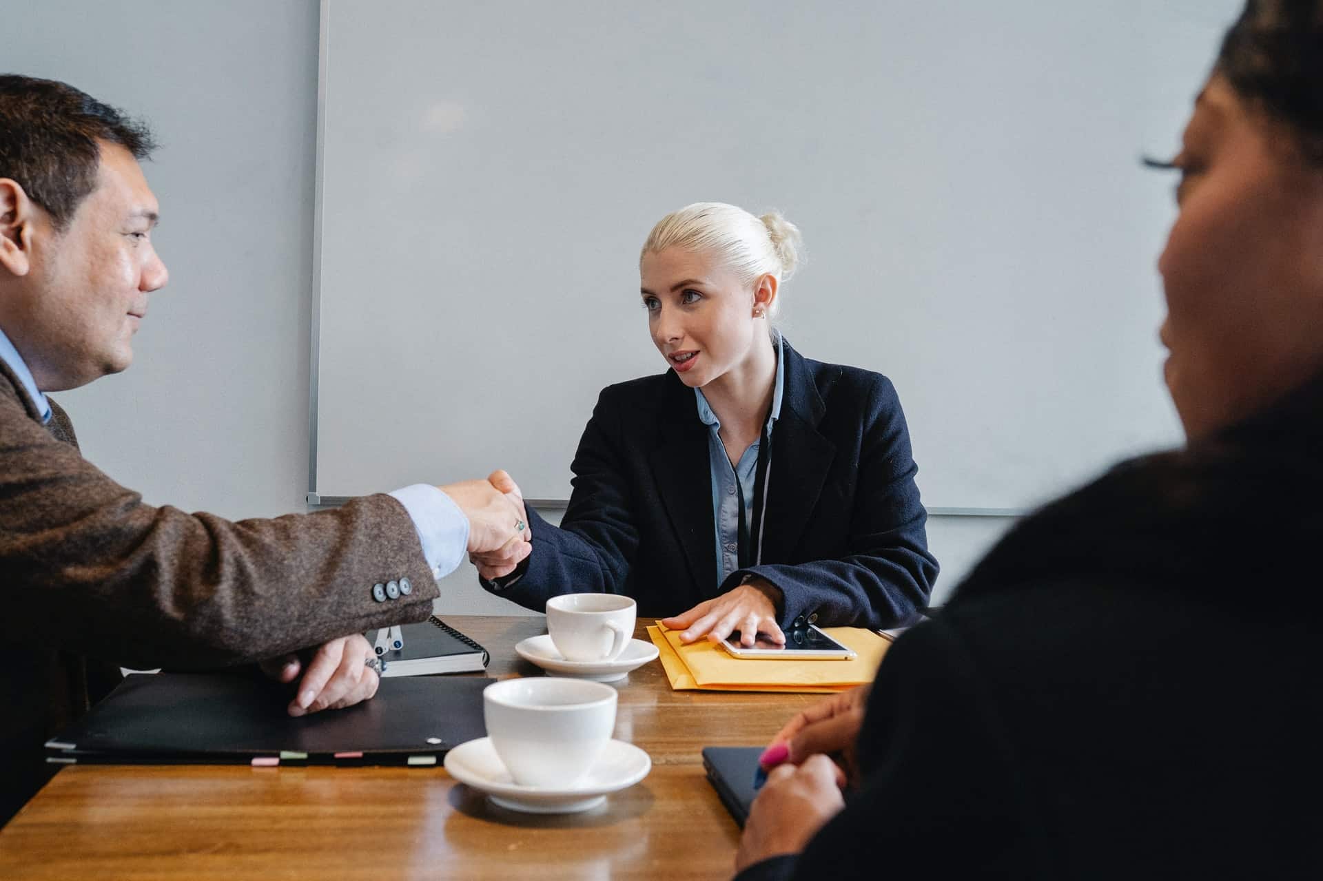 Multiple Business People Striking Deal in Office